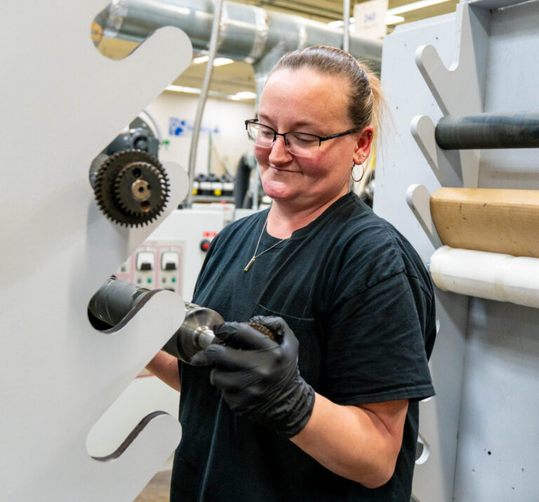 Print Source employee working with Flexo press tools.