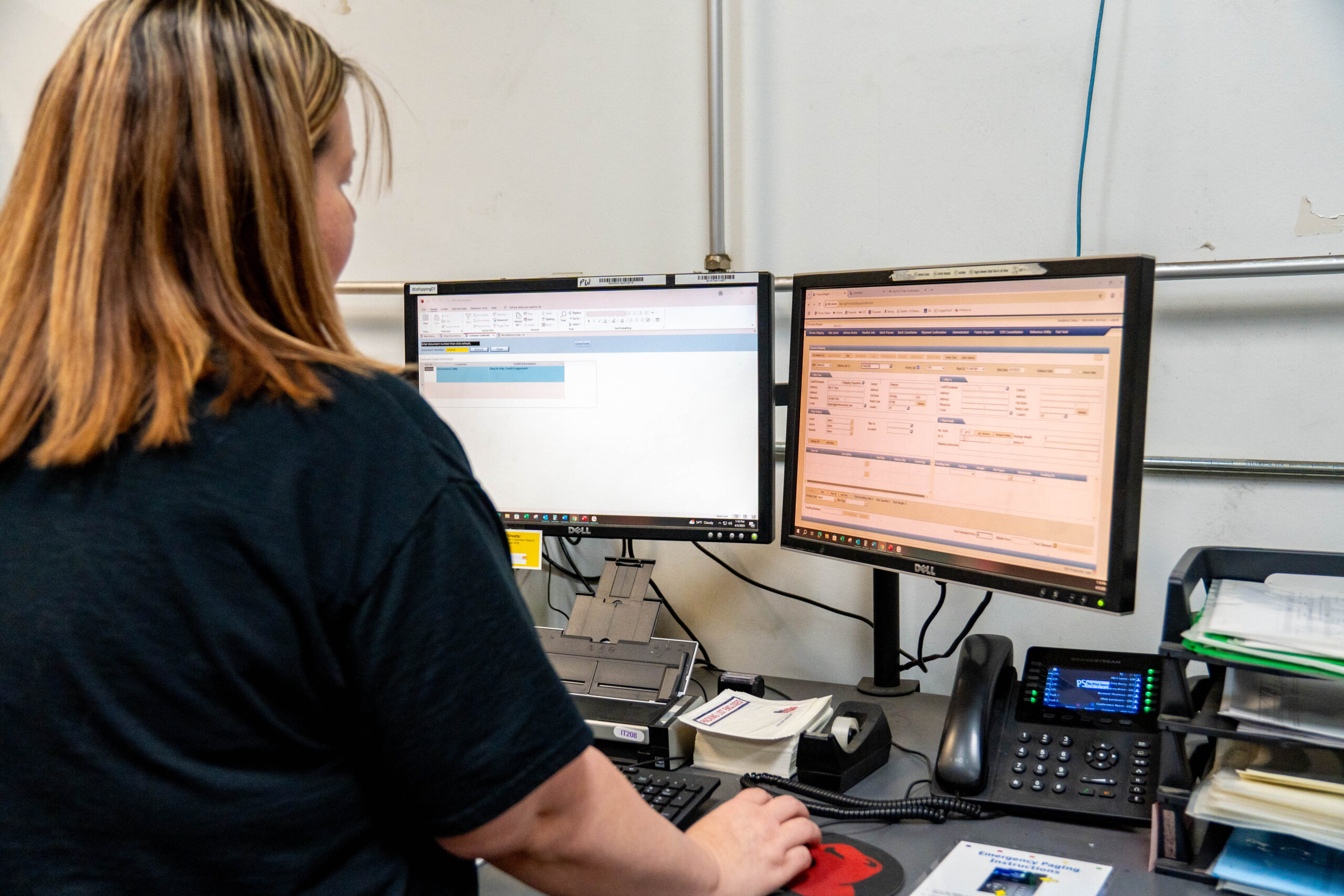 Print Source employee managing shipping orders.