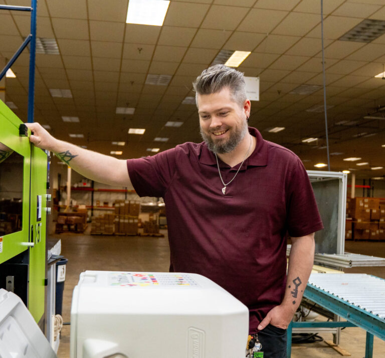 Print Source employee using a UV digital high-performance flatbed printer.