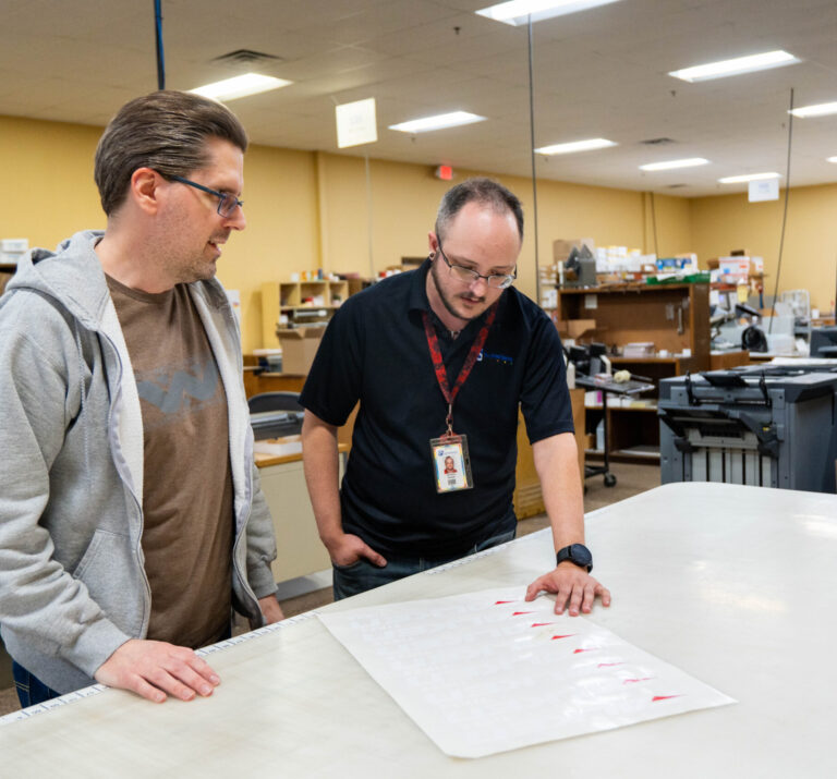Print Source employees collaborating on a project.